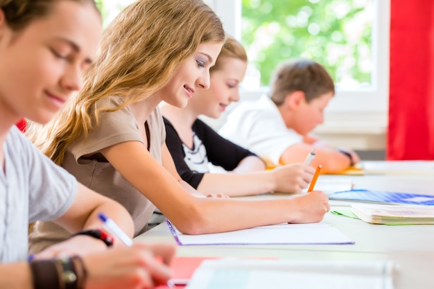 Foto studenti che scrivono una prova a scuola concentrandosi