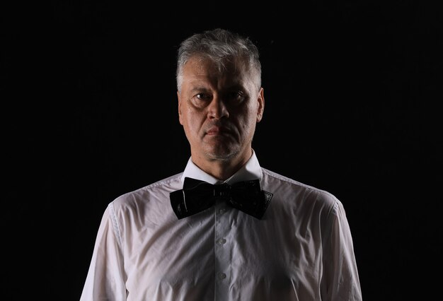 studio dark portrait of a gentleman on a black background