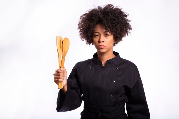 Studio die van een vrouwelijke chef-kok met een houten lepel is ontsproten