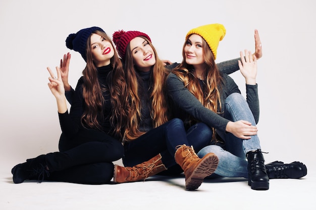 Studio fashion portrait of a group of three young beautiful model