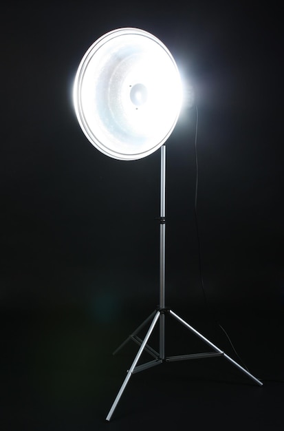 Photo studio flash with beauty dish on grey background