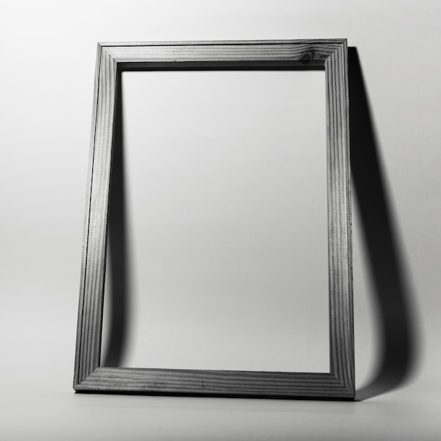 Studio image of frame on grey background. Black and white photo.