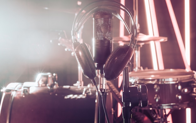 Studio microphone and headphones on a close-up stand, in a recording Studio or concert hall.