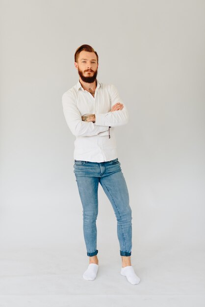 Studio photo of a beautiful young man with a beard