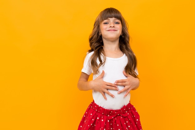 Studio photo of a funny caucasian girl on yellow