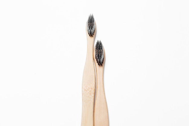 Studio photo of two bamboo eco toothbrushes, on white.