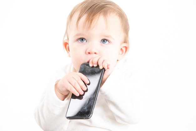 Studio photo with the white background of a baby39s face with a mobile in his hands