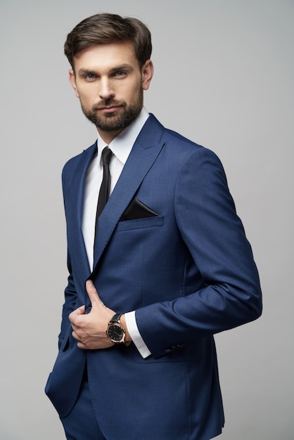 Studio photo of young handsome businessman wearing suit