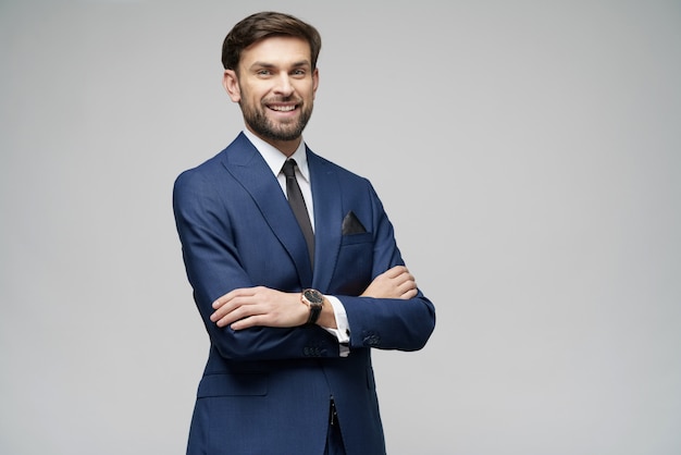 Studio photo of young handsome stylish businessman wearing suit