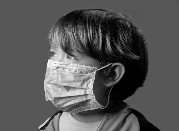 Studio portrait of a 4 years old male child wearing a protective mask