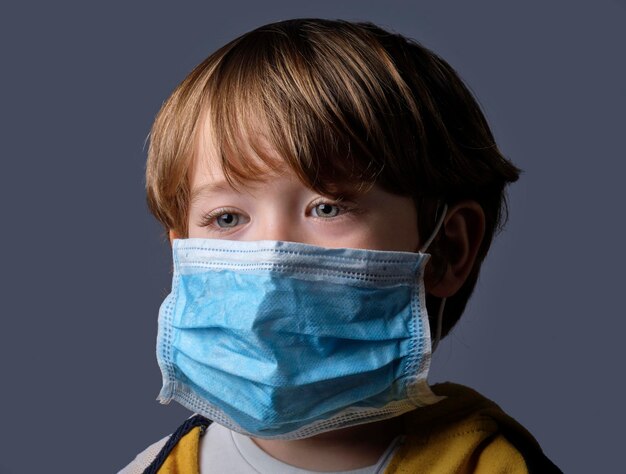 Studio portrait of a 4 years old male child wearing a protective mask