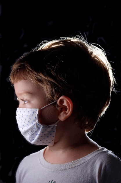 Studio portrait of a 4 years old male child wearing a protective mask