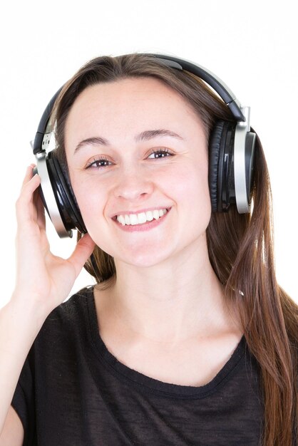 Studio portrait of adorable girl happy smiling relaxing in headphones