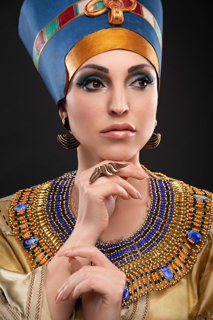 studio portrait of ancient egyptian woman in a crown, queen cleopatra