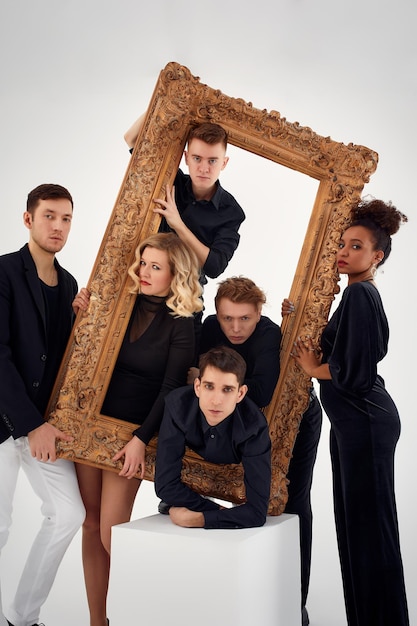 Studio portrait of Beautiful young diverse group of friends isolated on white background in the frame for a picture goofy face good mood