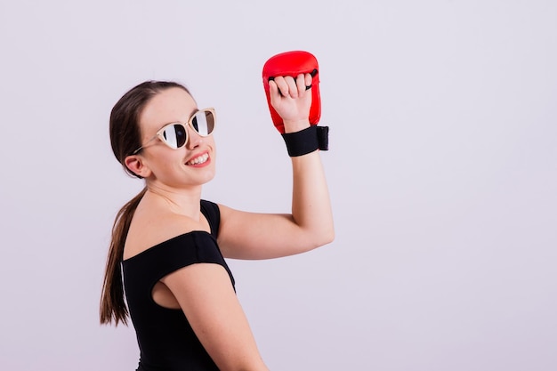 Studio portrait of a boxer female in bodysuit with gloves