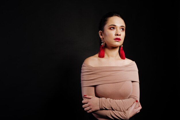 Studio portrait of brunette girl with make up on black background