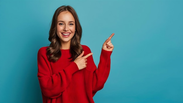 Studio portrait of charming satisfied young playful woman in stylish red loose sweater smiling bro