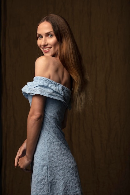 studio portrait on a dark background of a beautiful young woman