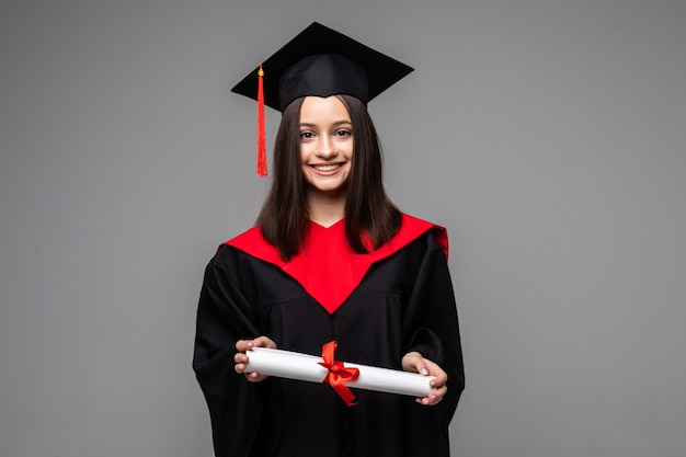 Studio portrait of funny excited joyful student girl with graduation certificate