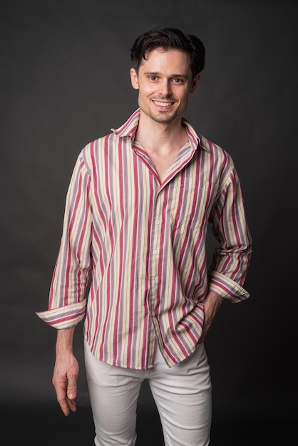 Studio portrait of handsome man against gray background