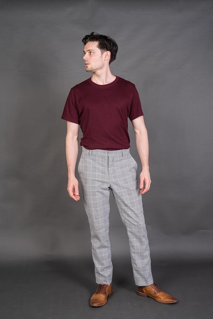 Studio portrait of handsome man against gray background