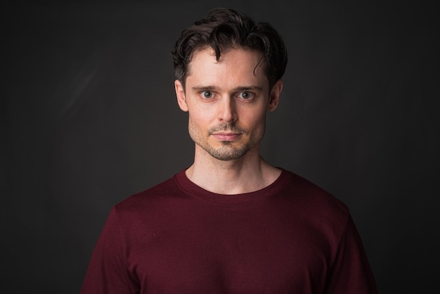 Studio portrait of handsome man against gray background