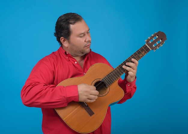 Studio portrait of a man playing an old Cuban tres