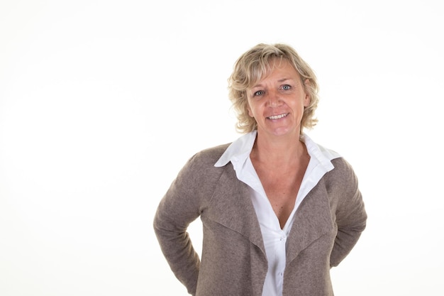 Studio portrait of mature blond middle age woman posing on white background