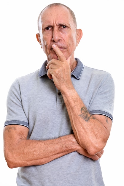 Studio portrait of senior man with short hair isolated against white