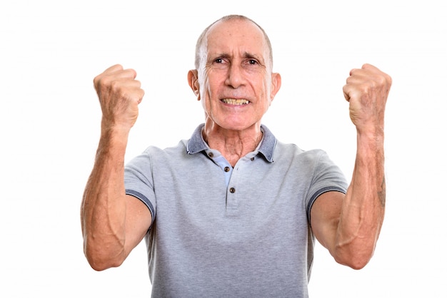 Studio portrait of senior man with short hair isolated against white