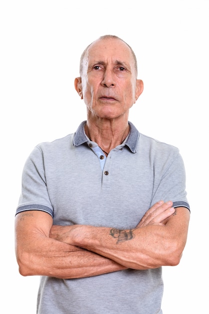 Studio portrait of senior man with short hair isolated against white