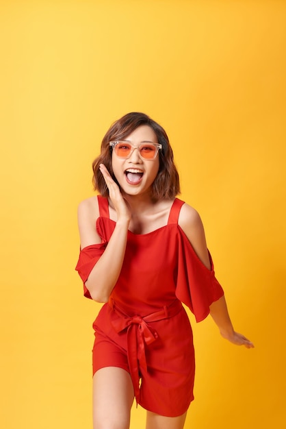 Studio portrait of surprised positive girl with short haircut dancing with smile