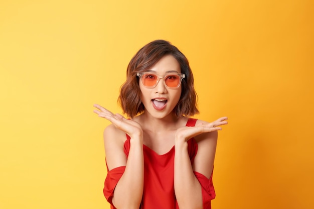 Studio portrait of surprised positive girl with short haircut dancing with smile