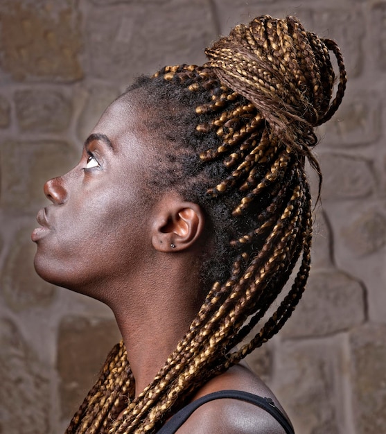 Studio portrait of a young black woman with braids