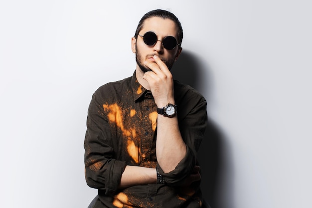 Studio portrait of young confident thoughtful man on white background