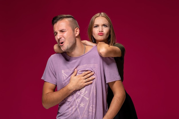 Studio portrait of a young couple in casual wear quarreled and taking a step towards reconciliation.