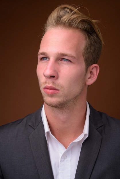 Studio portrait of young handsome businessman face