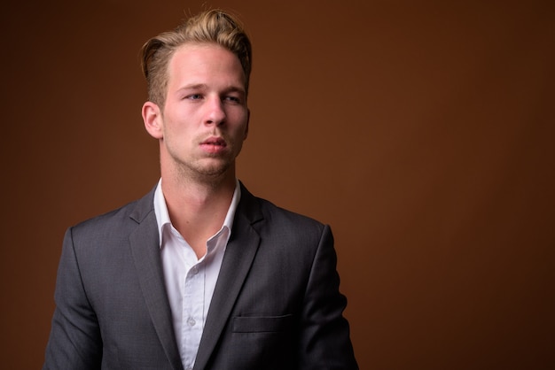 Studio portrait of young handsome businessman with suit