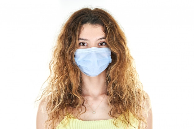 Studio portrait of young woman wearing a medical face mask