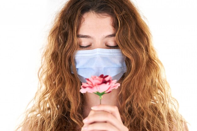 Studio portrait of young woman wearing a medical face mask