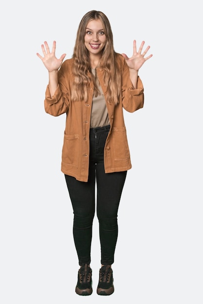 Foto studio portret van een blonde blanke vrouw met nummer tien met handen