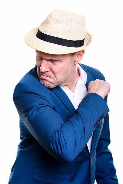 Studio shot of angry mature businessman looking back