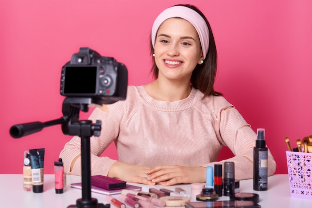 Studio shot of attractive young Caucasian woman blogger