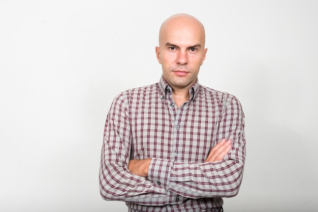 Studio shot of bald businessman against white background