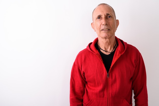 Studio shot of bald senior man against white background