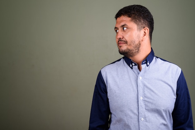 Studio shot of bearded businessman against colored