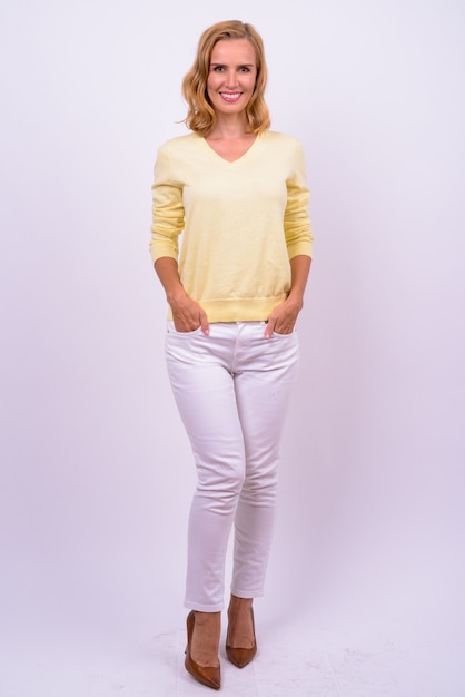 Studio shot of beautiful blonde businesswoman against white background