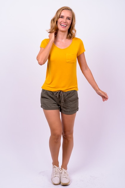 Studio shot of beautiful blonde tourist woman against white background