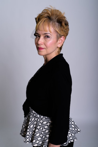 Studio shot of beautiful senior Asian businesswoman against white background